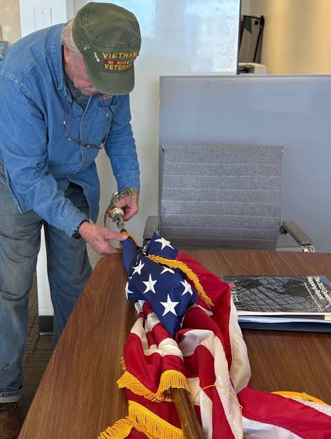 A Vietnam veteran reflects on his service and lifetime of duty as he folds a flag with care and honor.